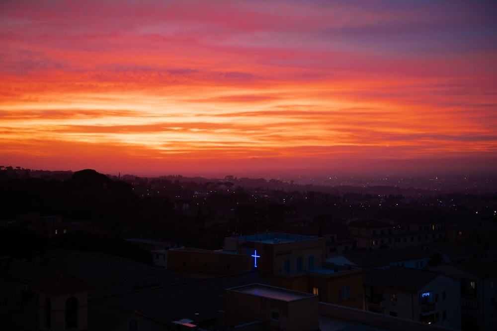 a sunset view of a city from a rooftop