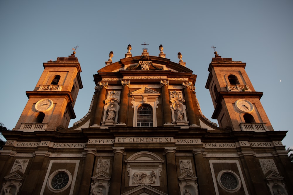 a large building with two towers and a clock on it