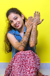 Smiling client showing off fresh henna tattoo on wrist