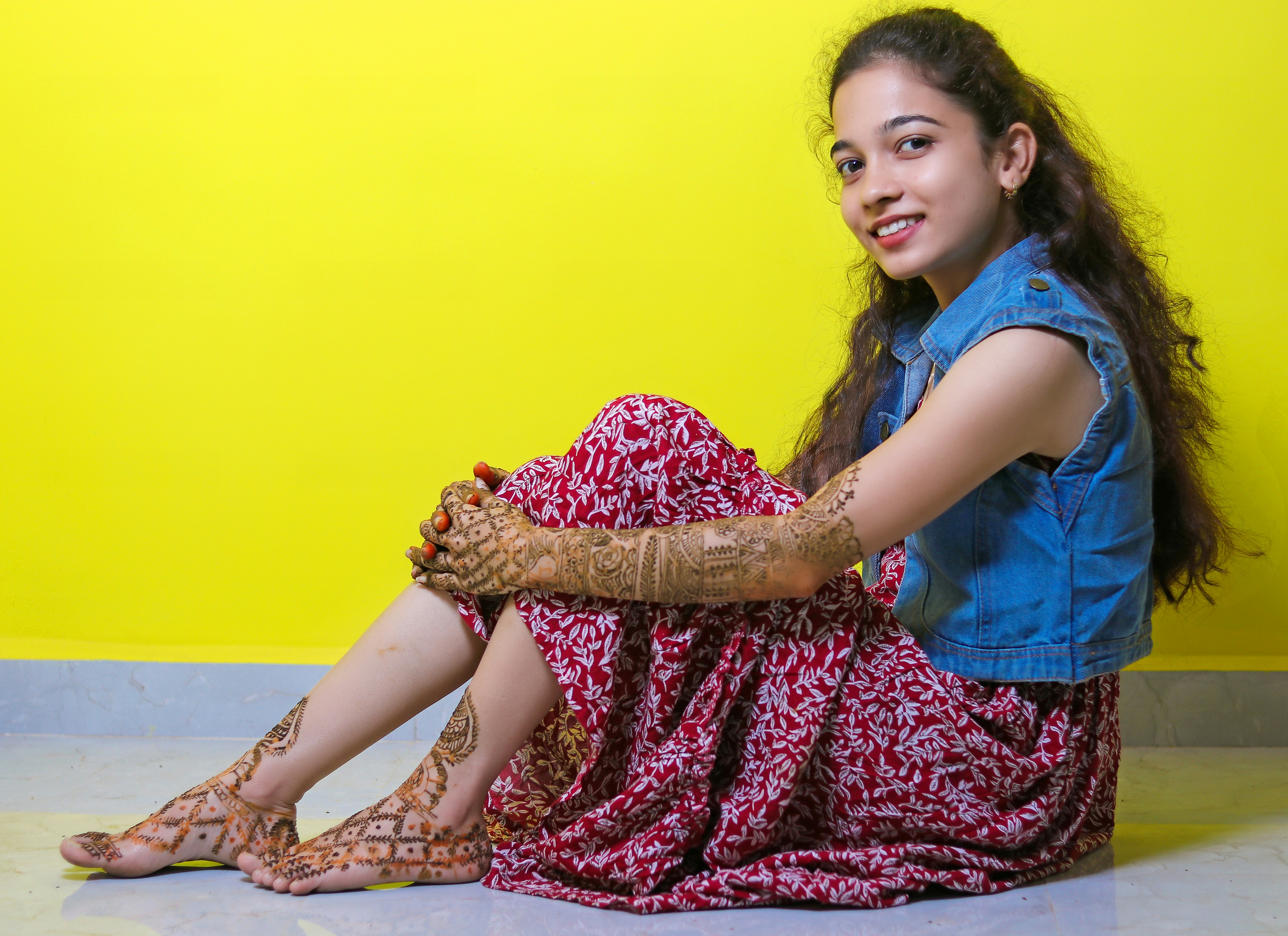 a woman sitting on the floor with her legs crossed