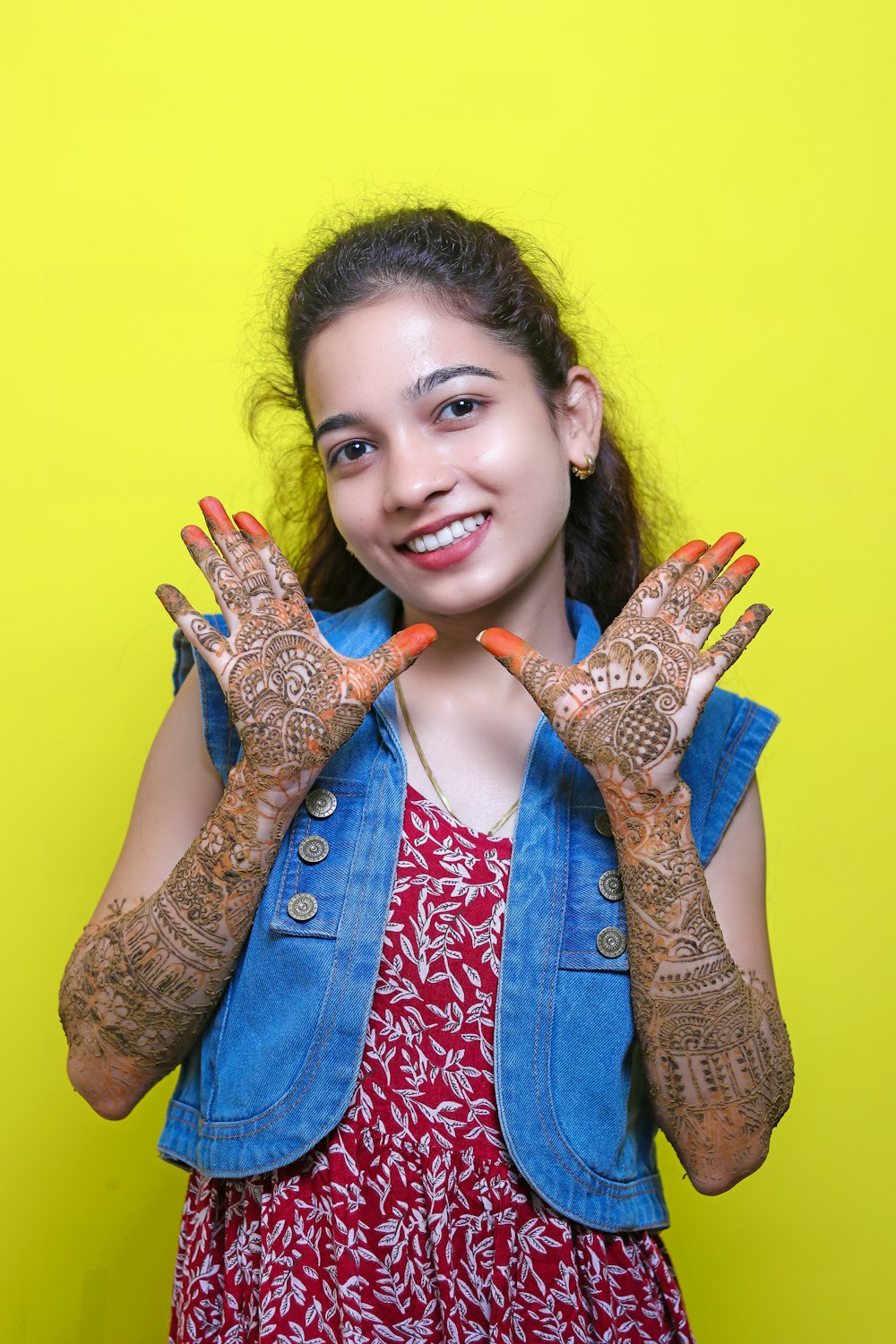 a woman with her hands painted with henna