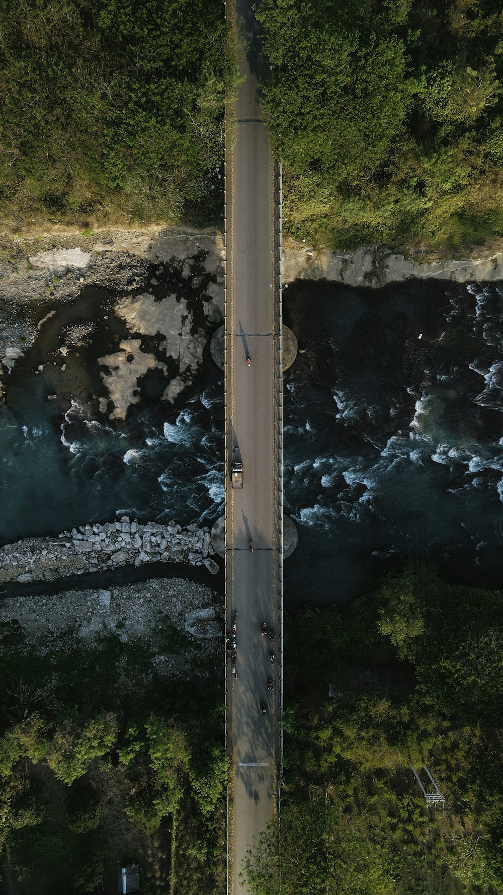 an aerial view of a road near a body of water