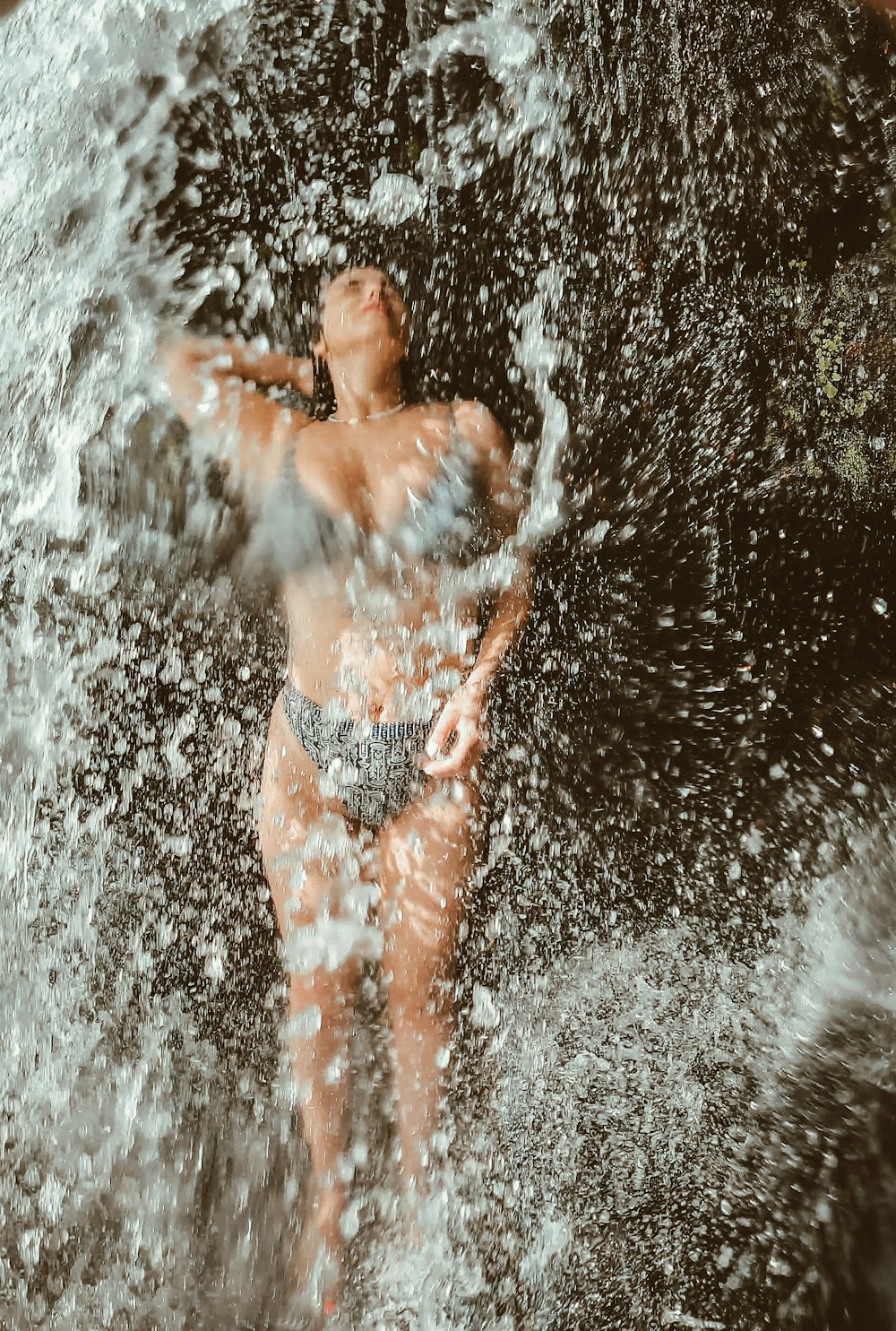 a woman in a bikini standing in the water