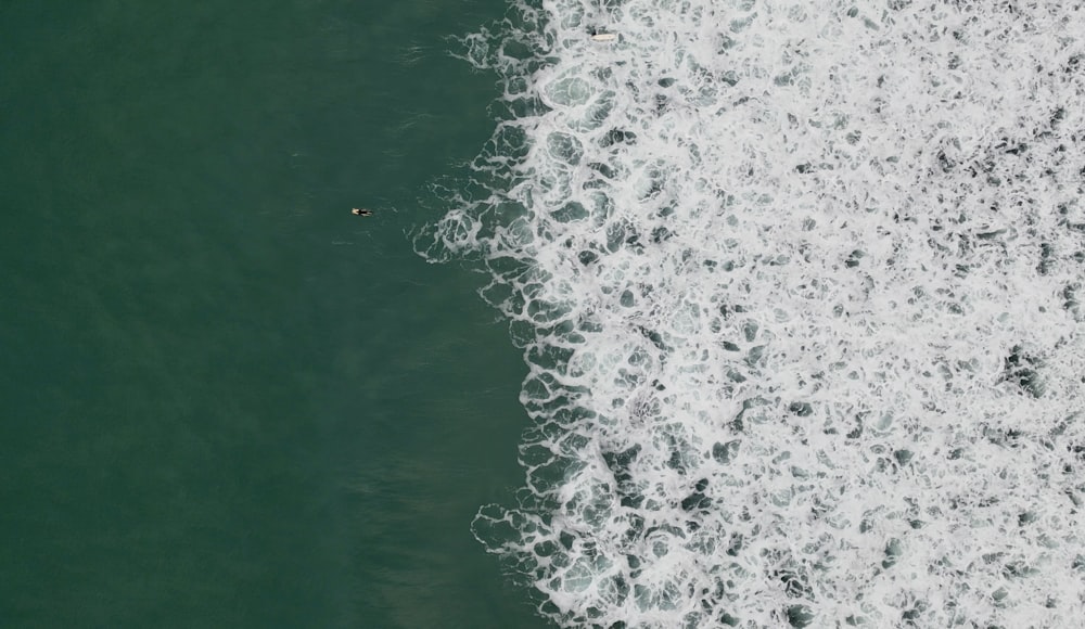 a person riding a surfboard on a wave in the ocean