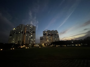 Elegant twilight view of Savyavasa’s sleek high-rise towers glowing against the night sky.