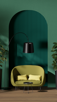 A stylish interior featuring a green circular-patterned wall, a lime green sofa with two matching cushions, a sleek black floor lamp, and a small black coffee table. The space is flanked by tall potted plants, and the wooden floor adds warmth to the modern aesthetic.