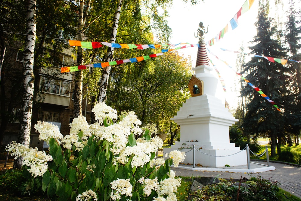 a small white tower with a clock on top of it