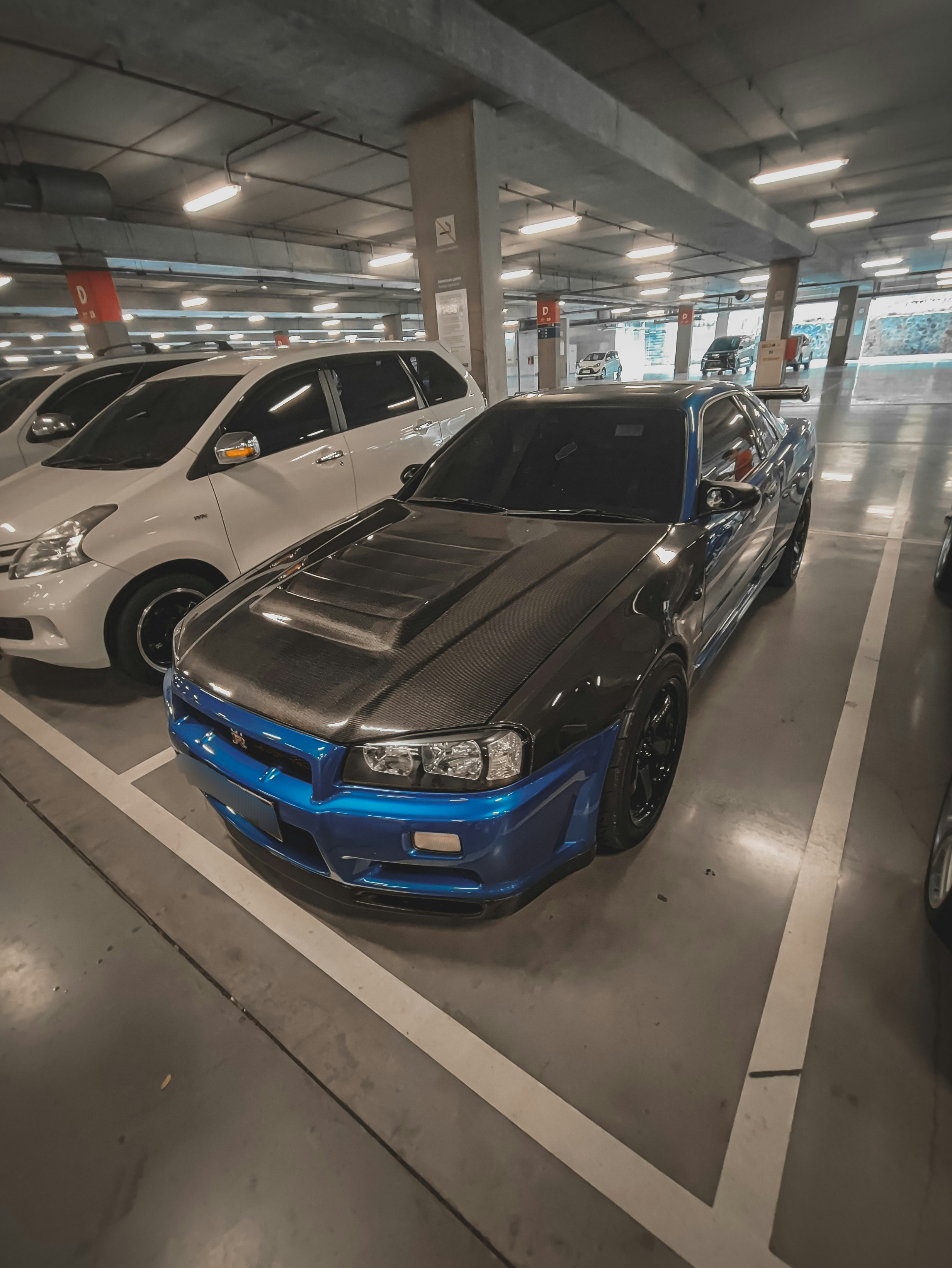 a parking garage with several cars parked in it