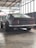 A classic car being showcased after restoration in a garage.