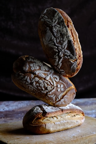 A close-up of artisanal bread loaves stacked on a tray.