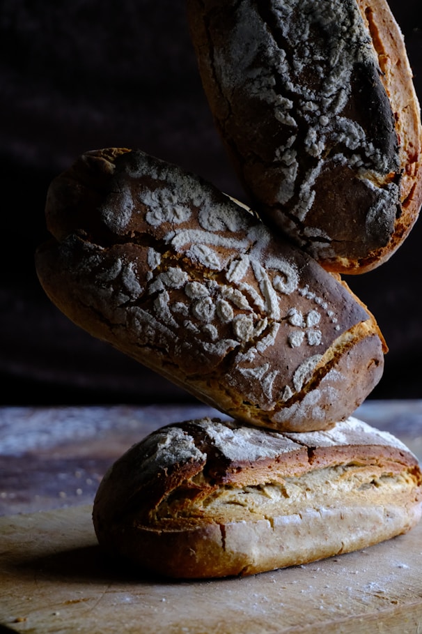Artisan sourdough loaves stacked neatly, showcasing their textured crusts and airy interiors.
