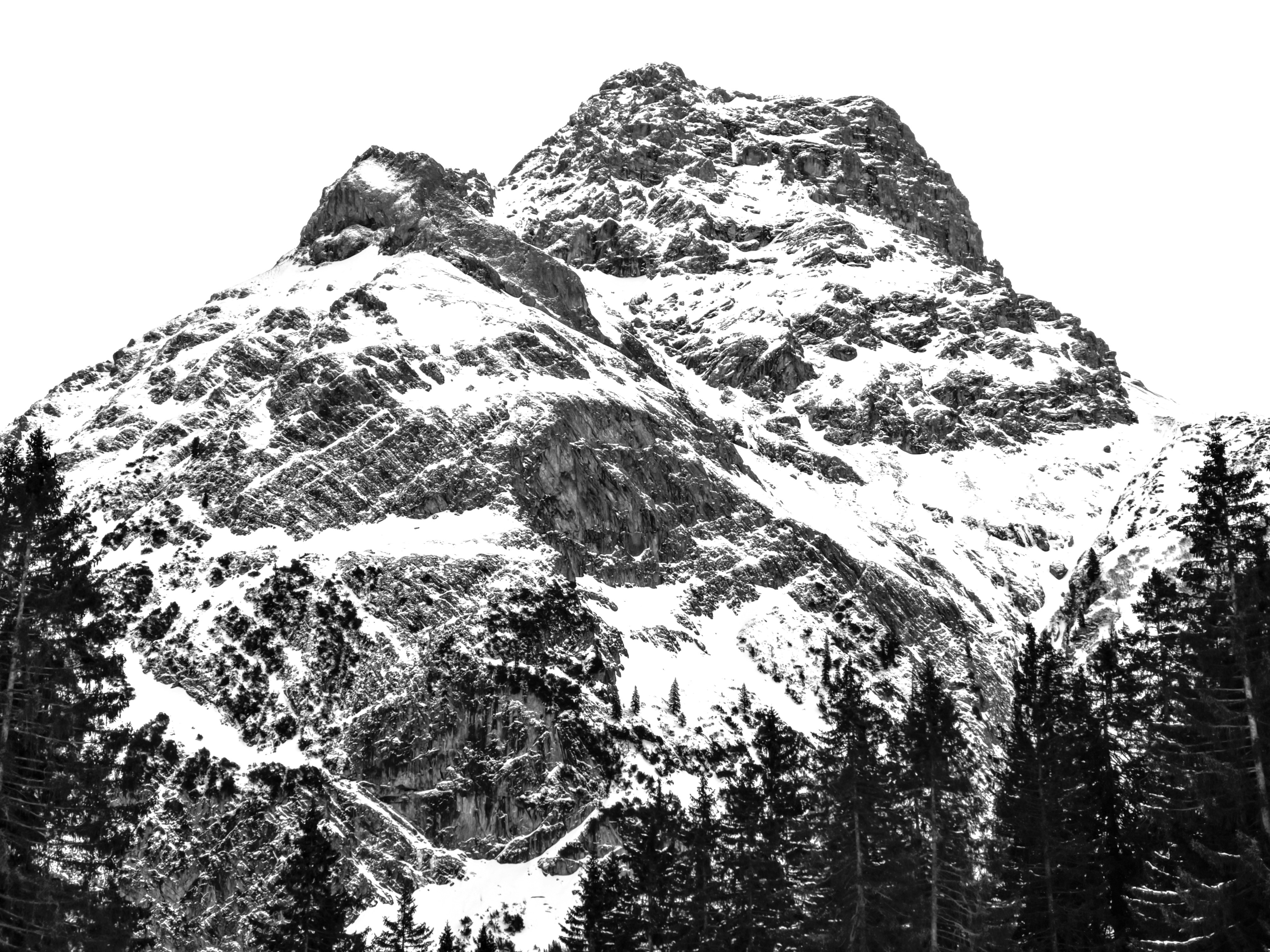 a black and white photo of a snow covered mountain