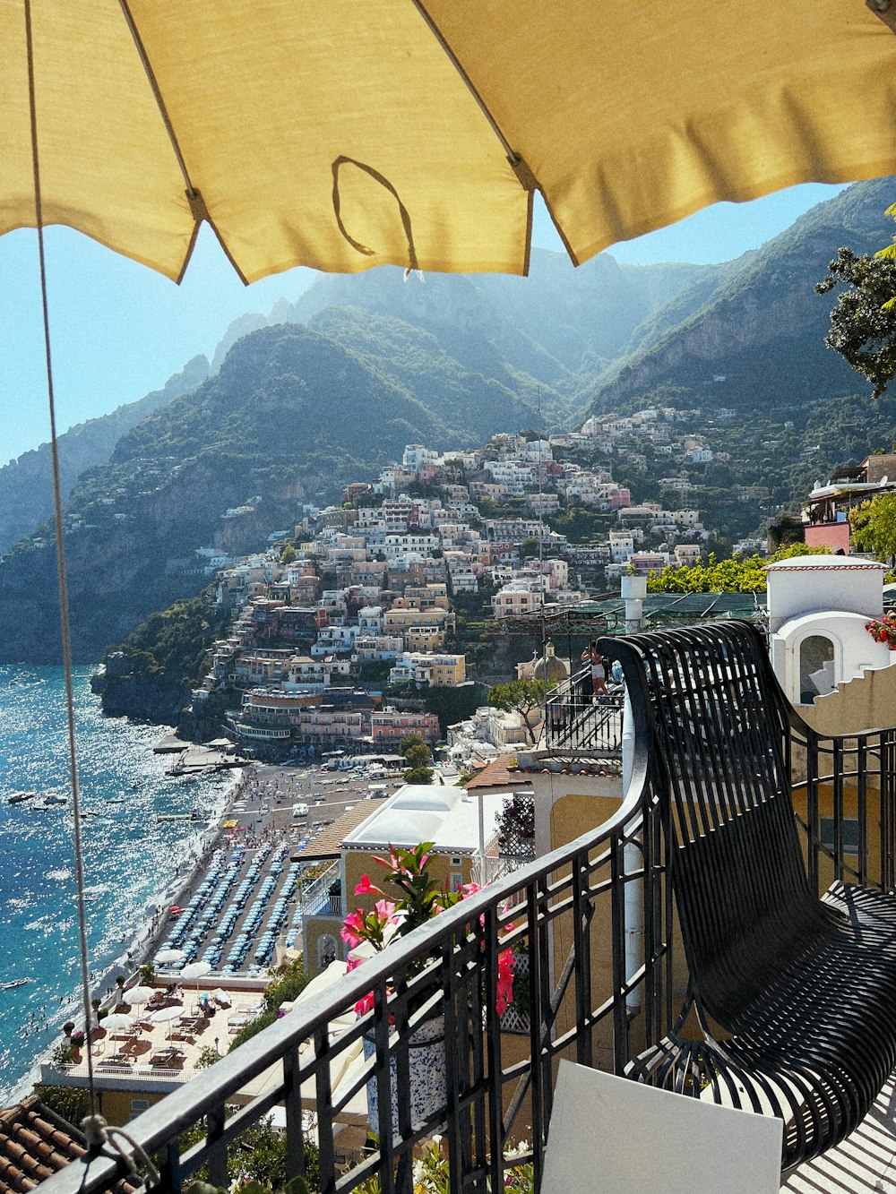 a balcony with a view of a town and the ocean