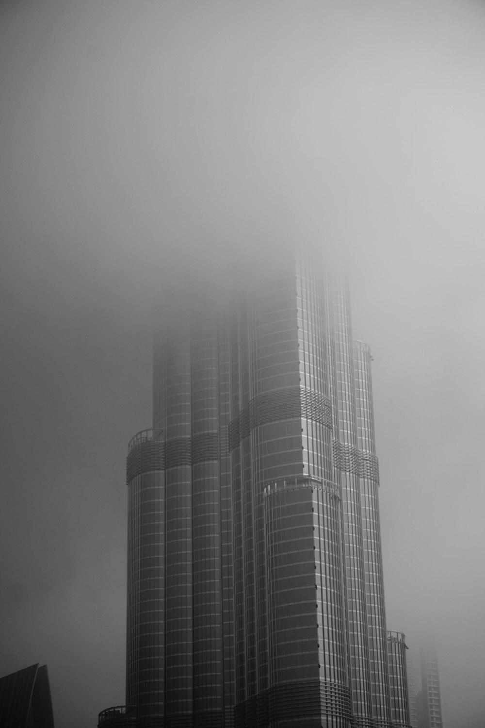 a black and white photo of a foggy city