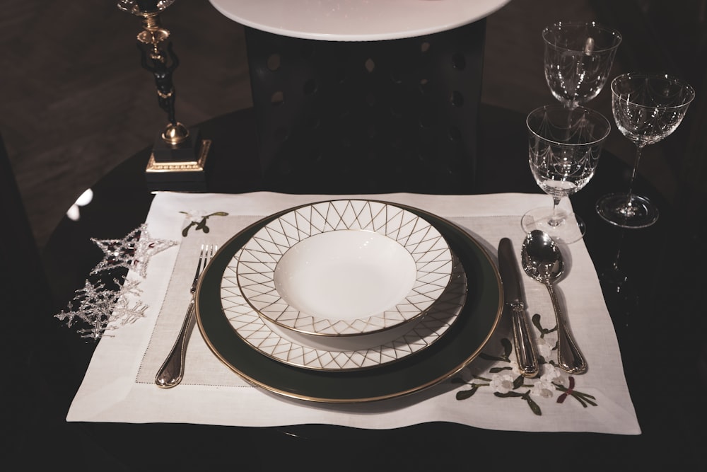 a table set with a white plate and silverware
