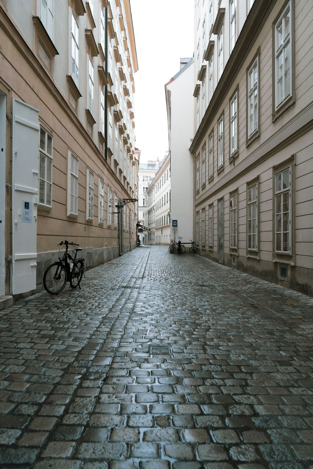 a bike is parked on a cobblestone street