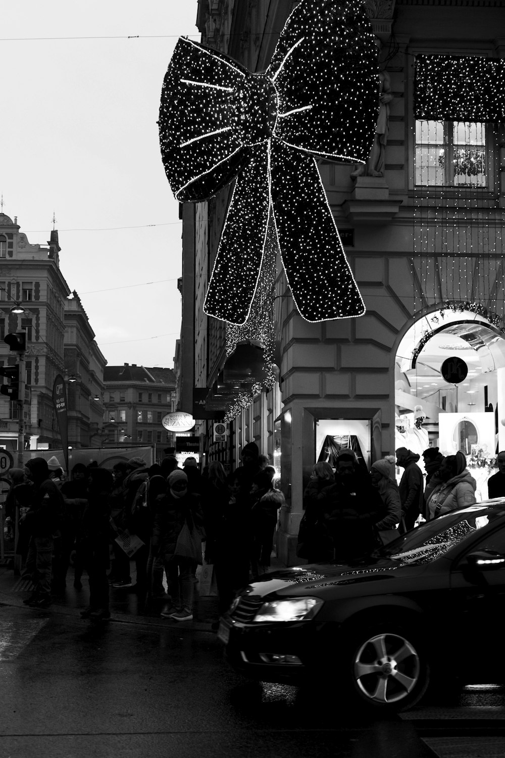 a black and white photo of people walking on a street