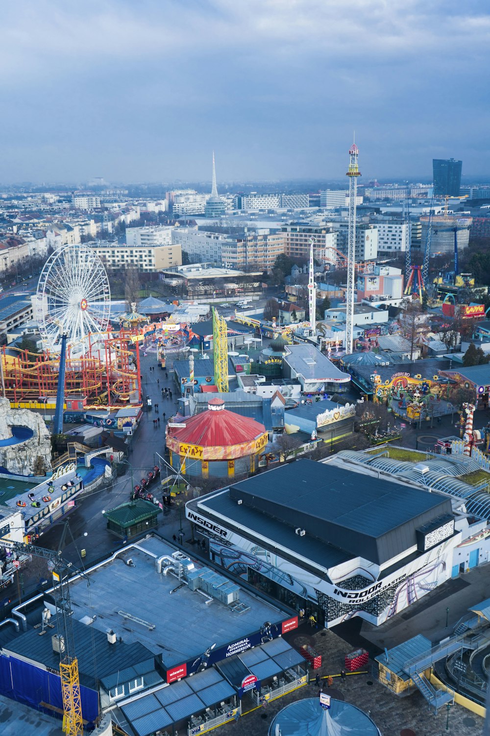 an aerial view of an amusement park with a ferris wheel