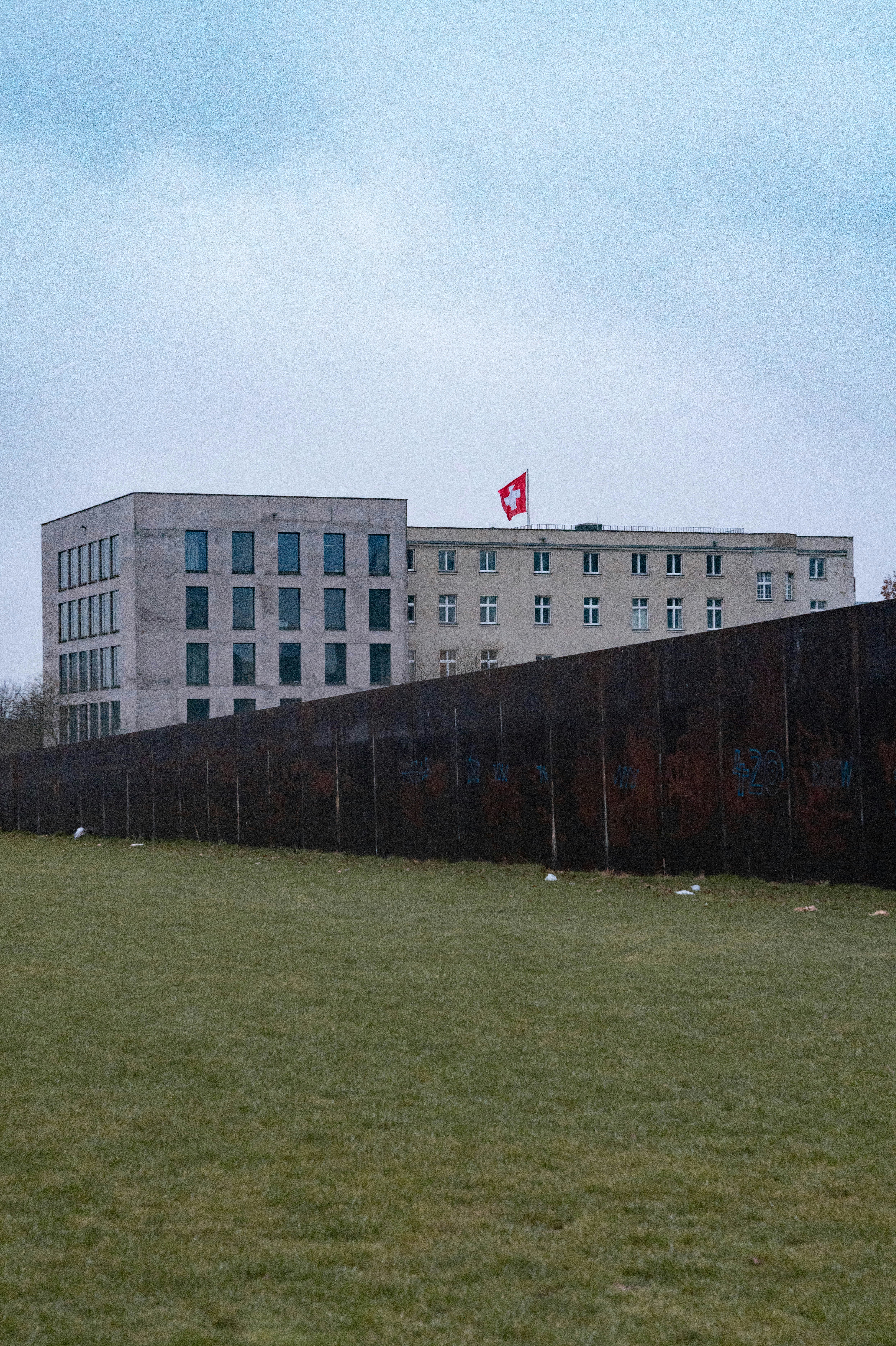 A large grassy field with a building in the background