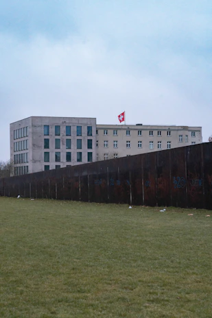 Exterior view of a completed hospital building with Swiss and Peruvian flags.