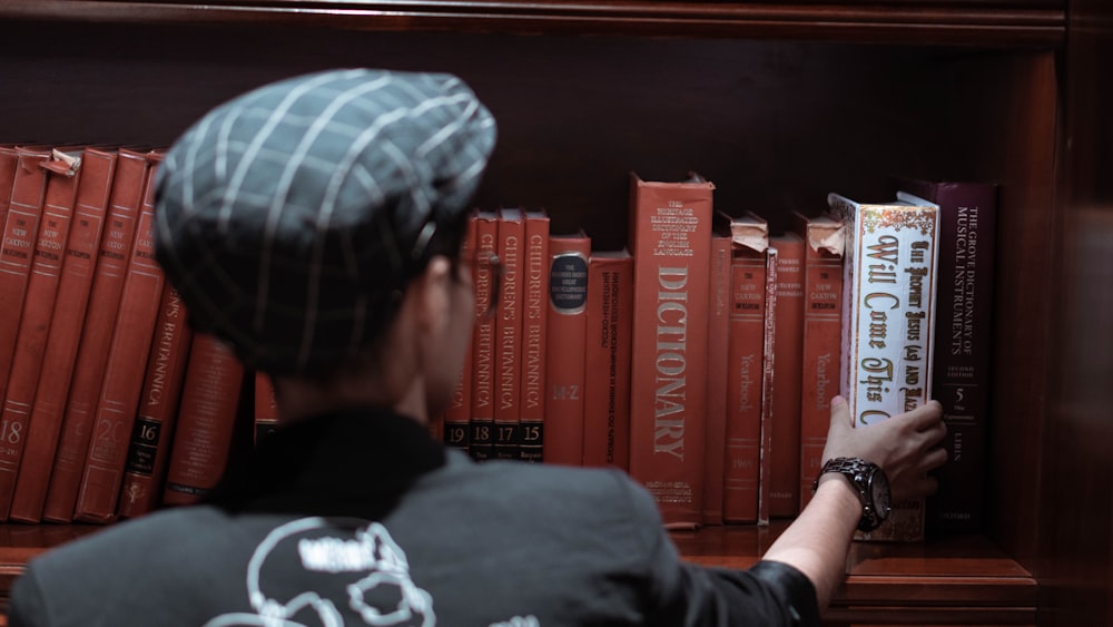 a man reading a book in a library