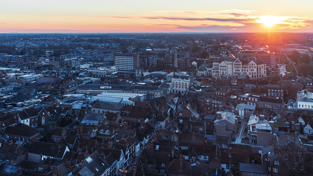 the sun is setting over a large city