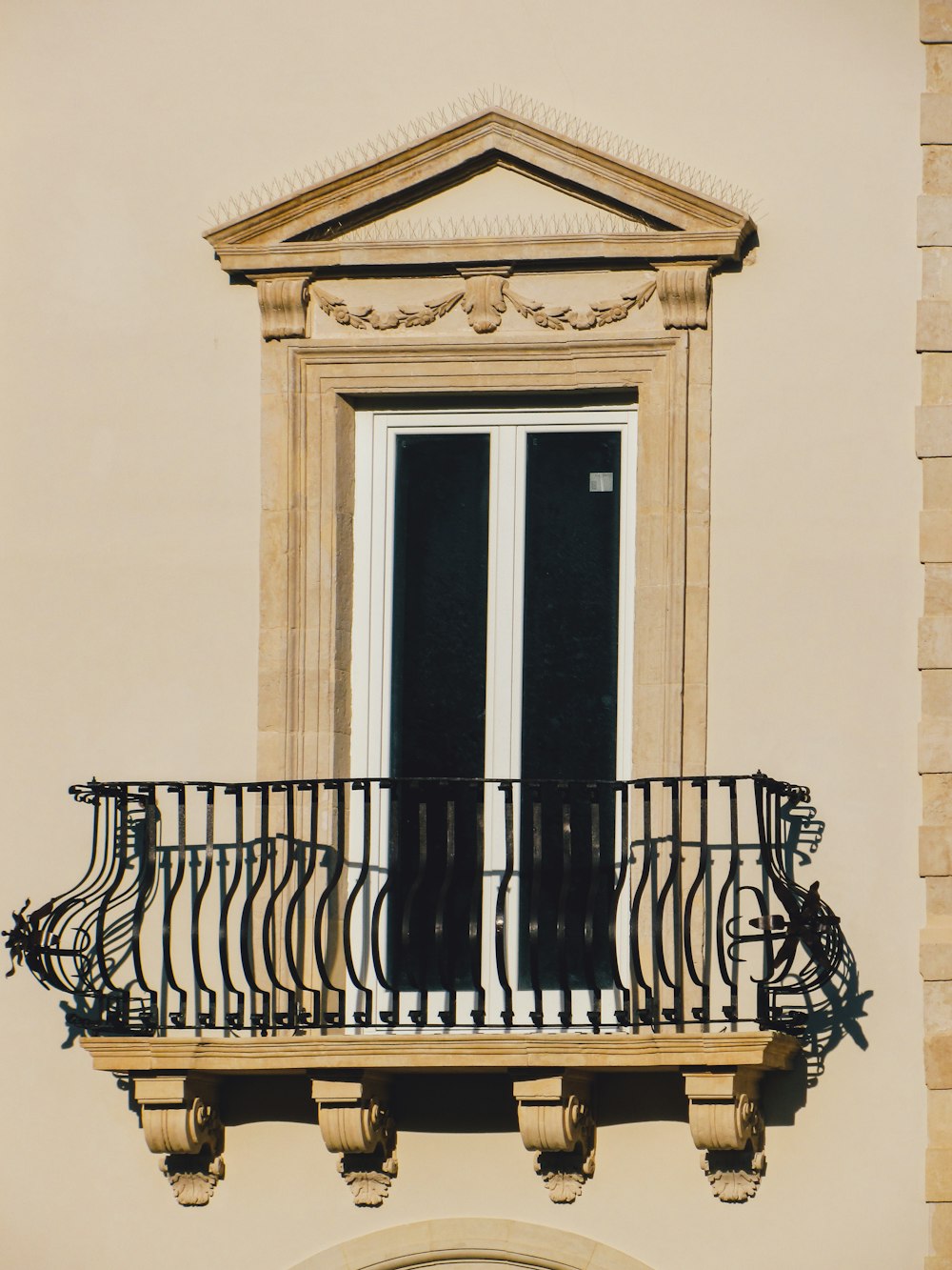 a balcony with wrought iron railing and a clock