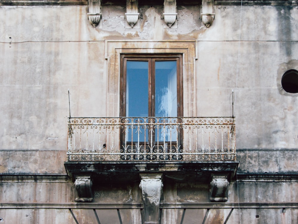 an old building with a balcony and a window