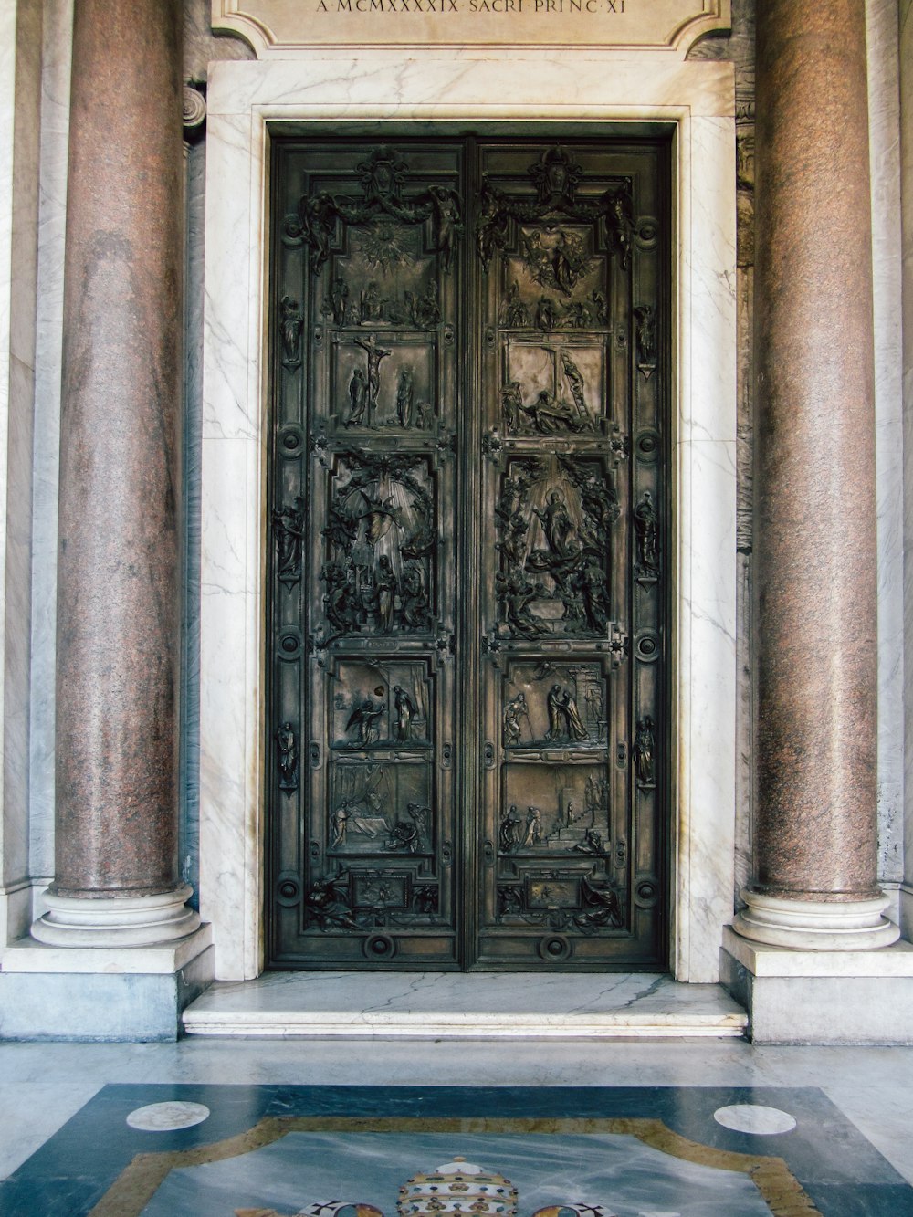 a large metal door sitting inside of a building