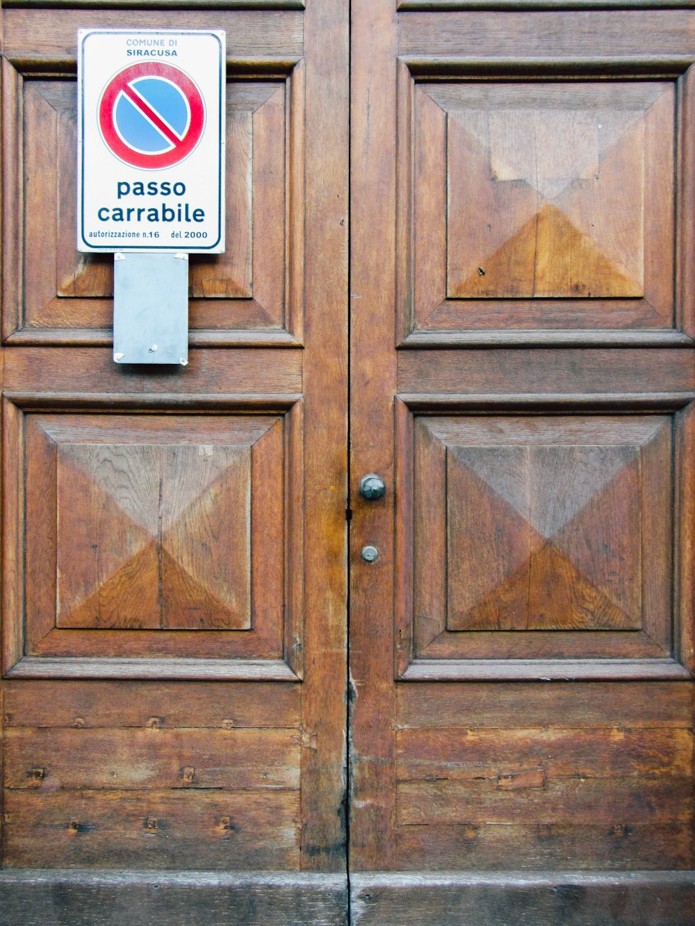 a wooden door with a no parking sign on it