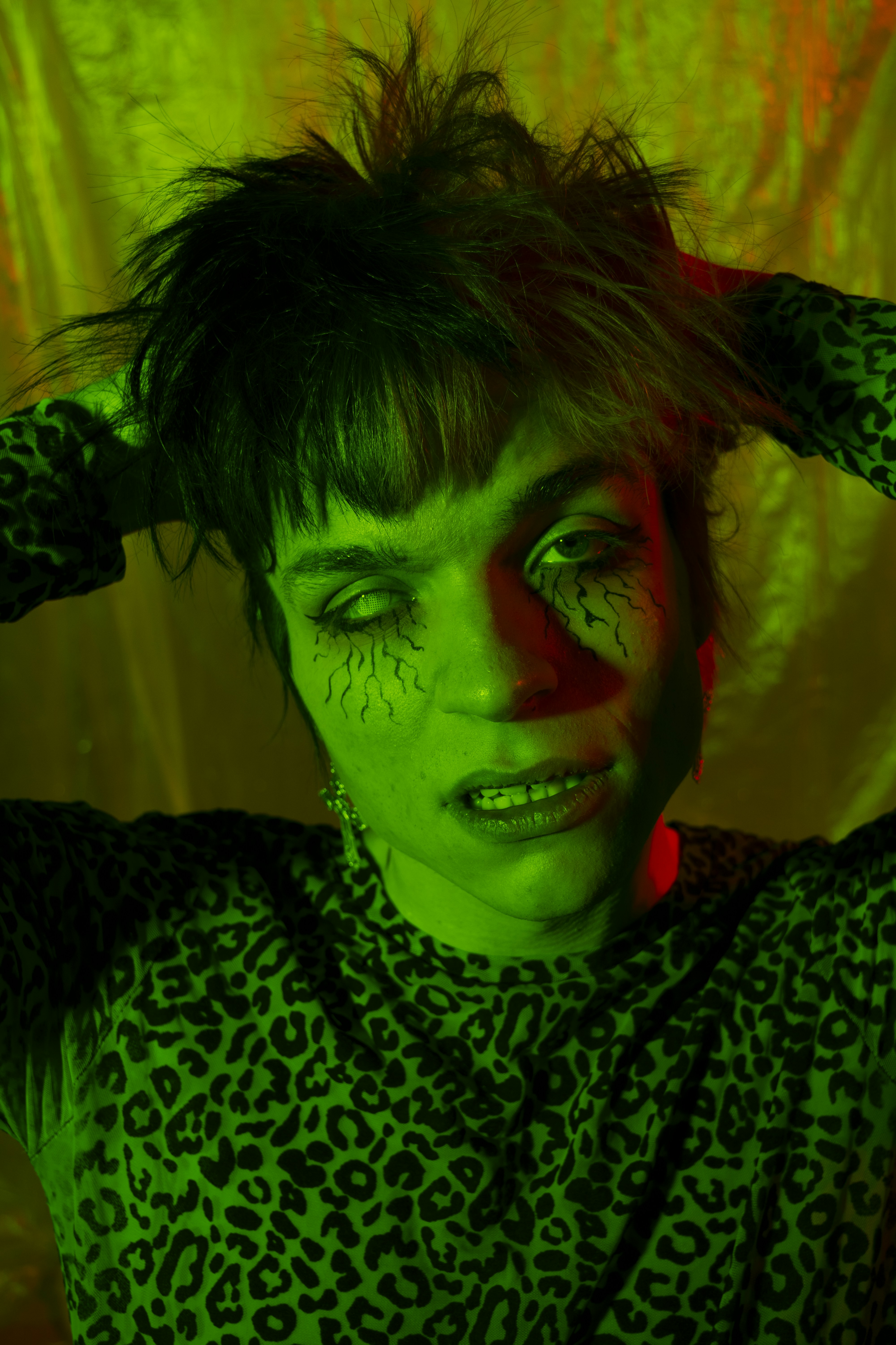 a woman with green makeup and black hair