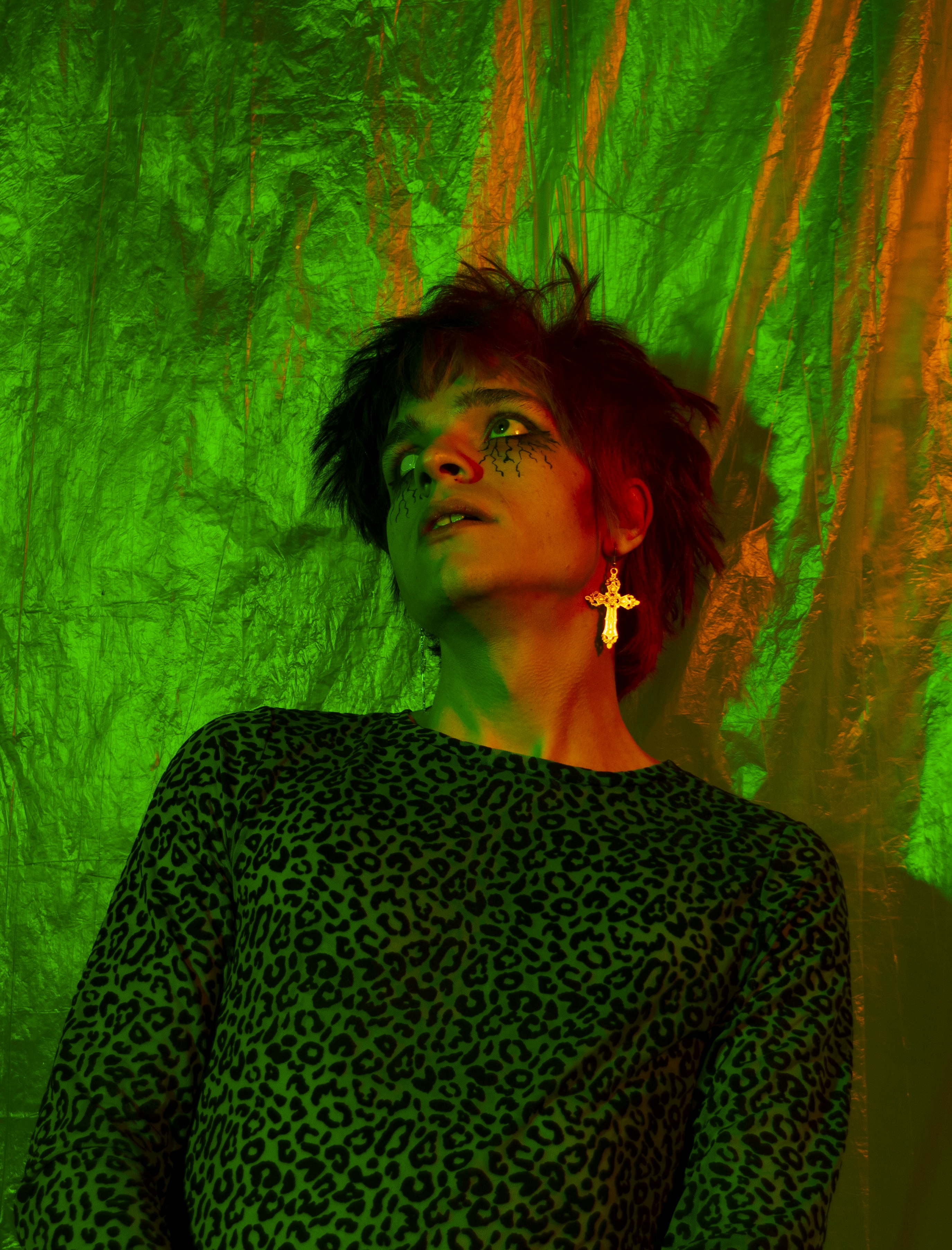 a woman standing in front of a green curtain