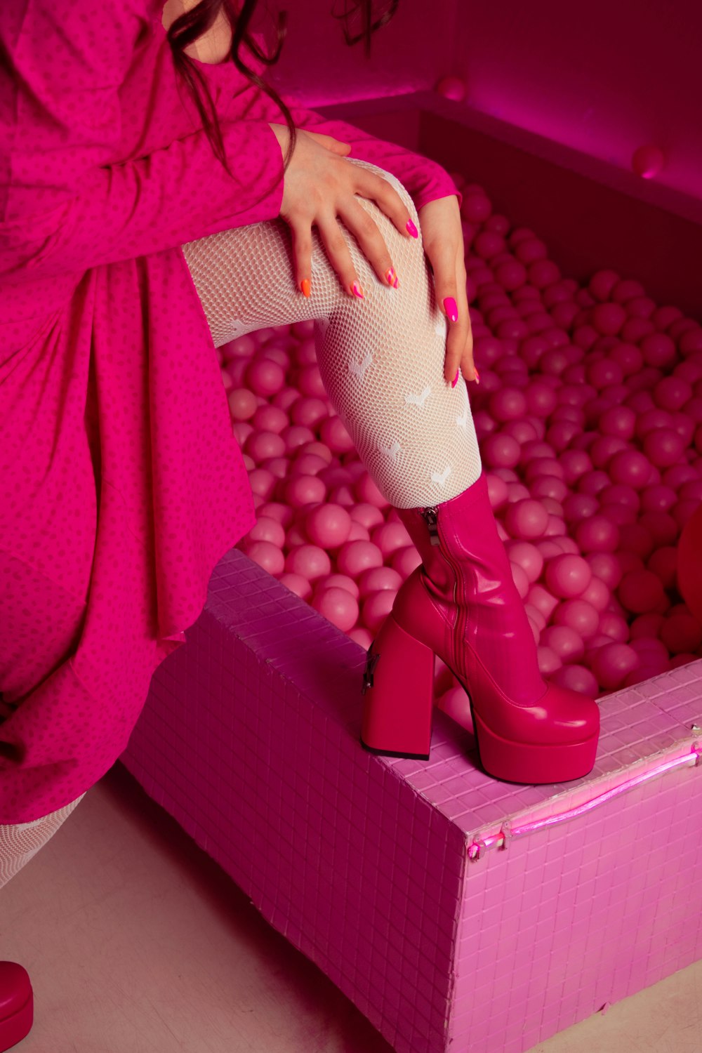 a woman in a pink dress and pink boots