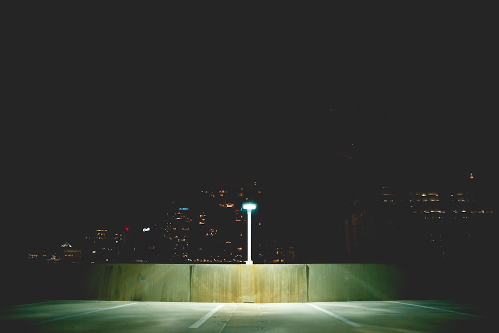 an empty parking lot at night with a street light