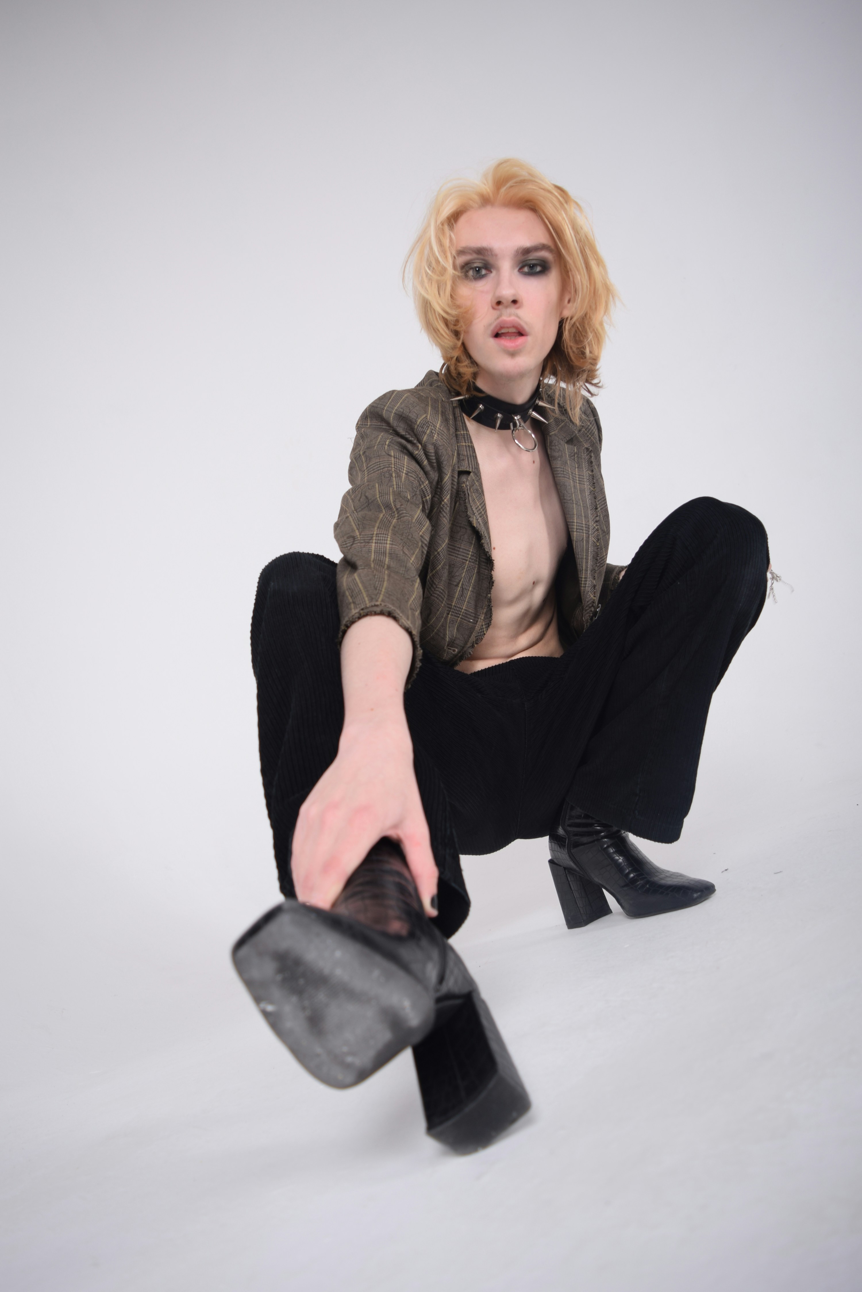 a woman in black pants and a brown jacket