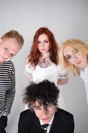 Group shot of diverse men and women wearing different styles of toshmi wigs in bright natural light.
