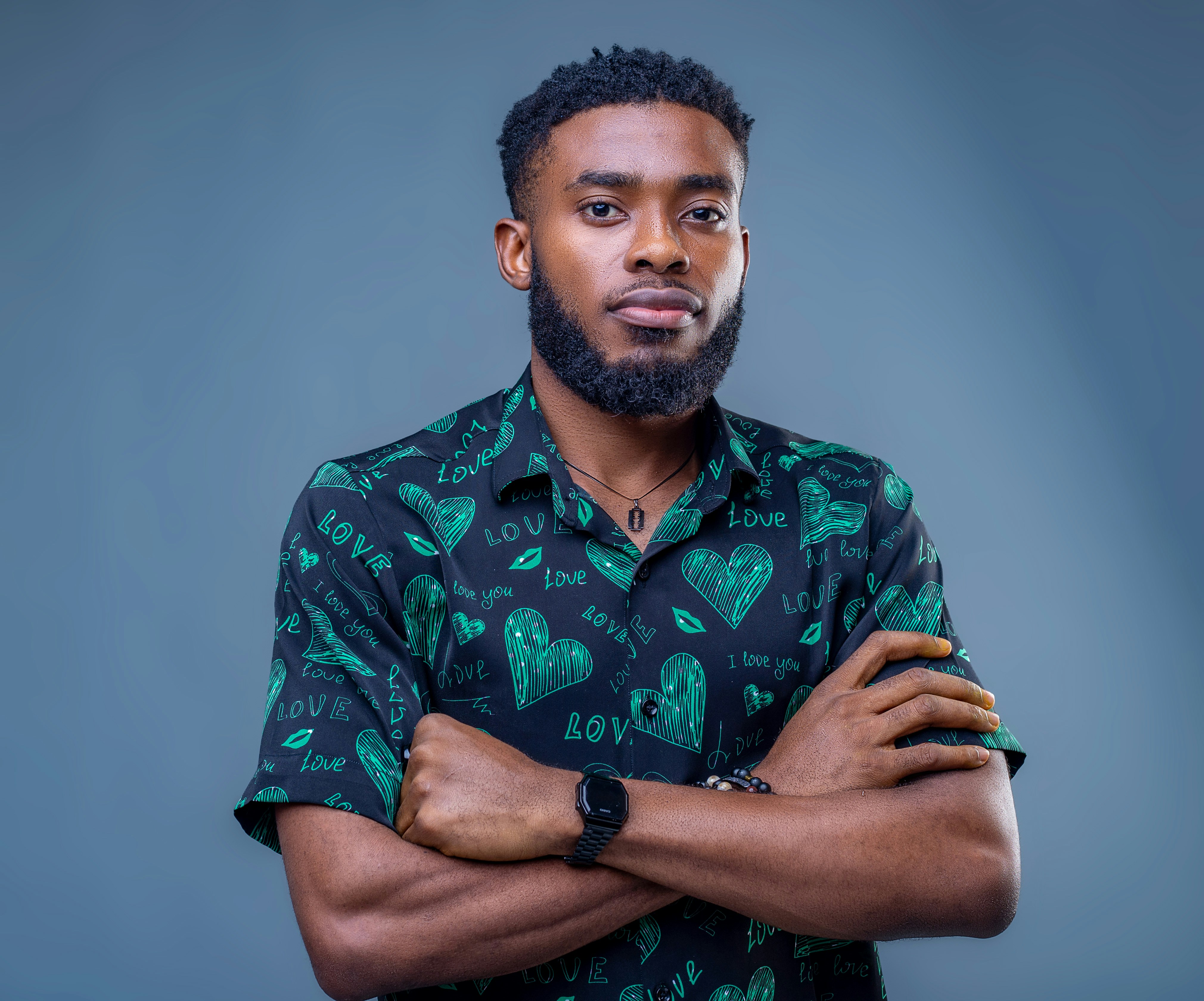 a man with a beard wearing a green shirt