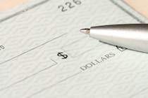a pen sitting on top of a cheque paper