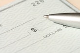 a pen sitting on top of a cheque paper
