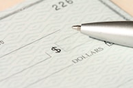 a pen sitting on top of a cheque paper