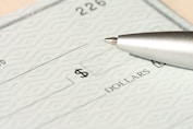 a pen sitting on top of a cheque paper