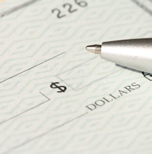 a pen sitting on top of a cheque paper