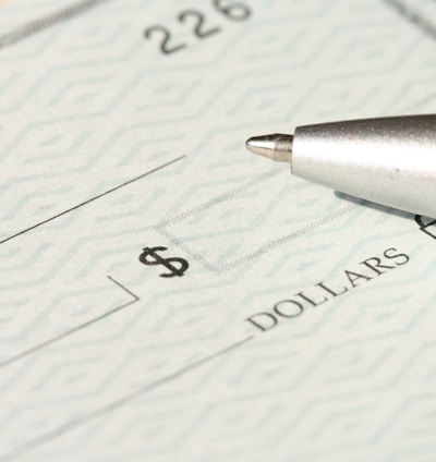 a pen sitting on top of a cheque paper