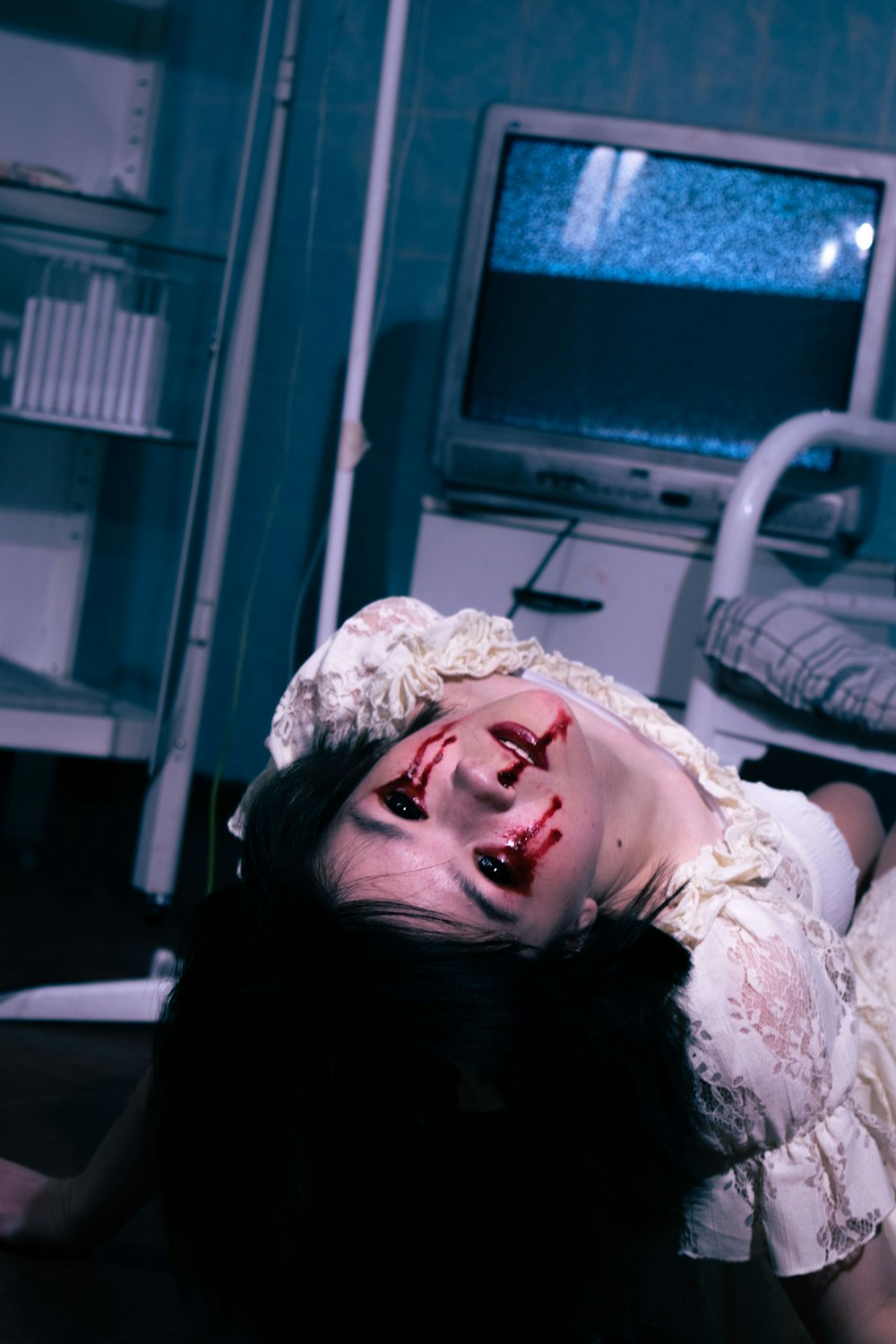 a woman with blood on her face laying on the floor