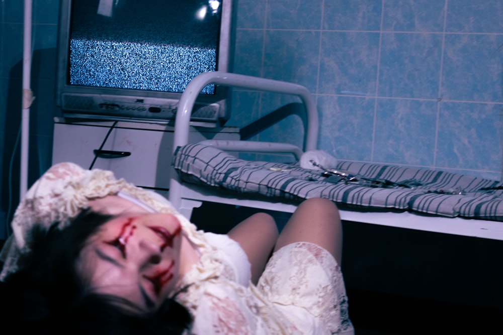 a woman laying down in a hospital room
