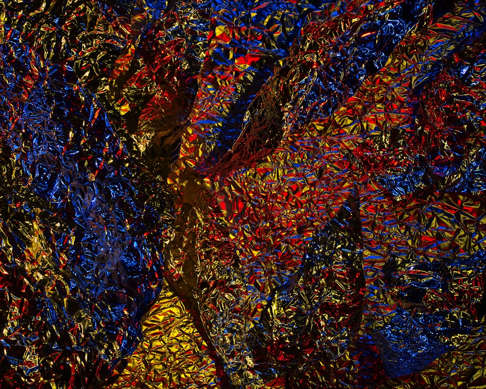 an abstract painting with red, yellow, and blue colors
