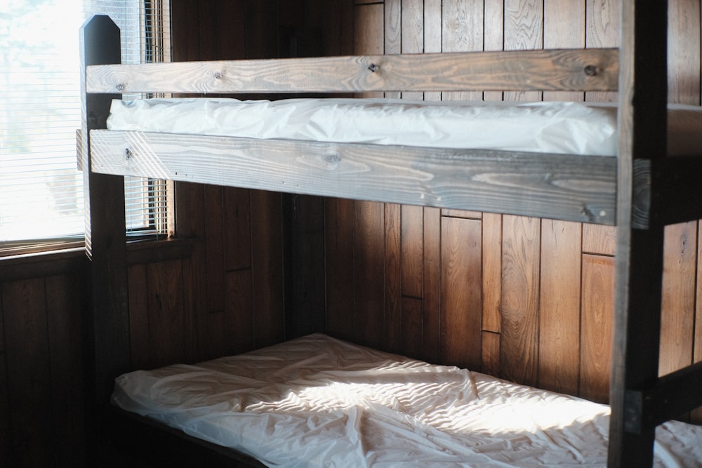 a bunk bed in a room with wooden walls