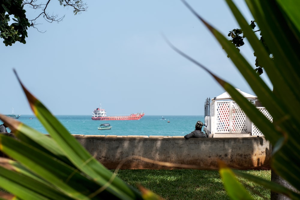 a boat is in the water near a concrete wall