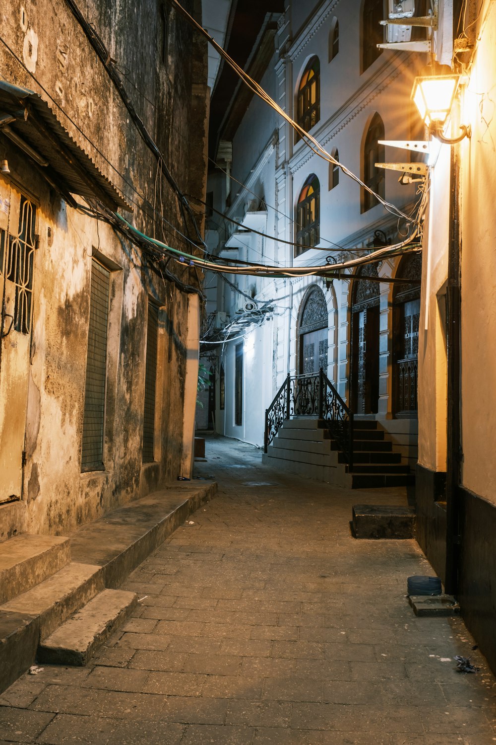 a narrow alley way with stairs leading to a building