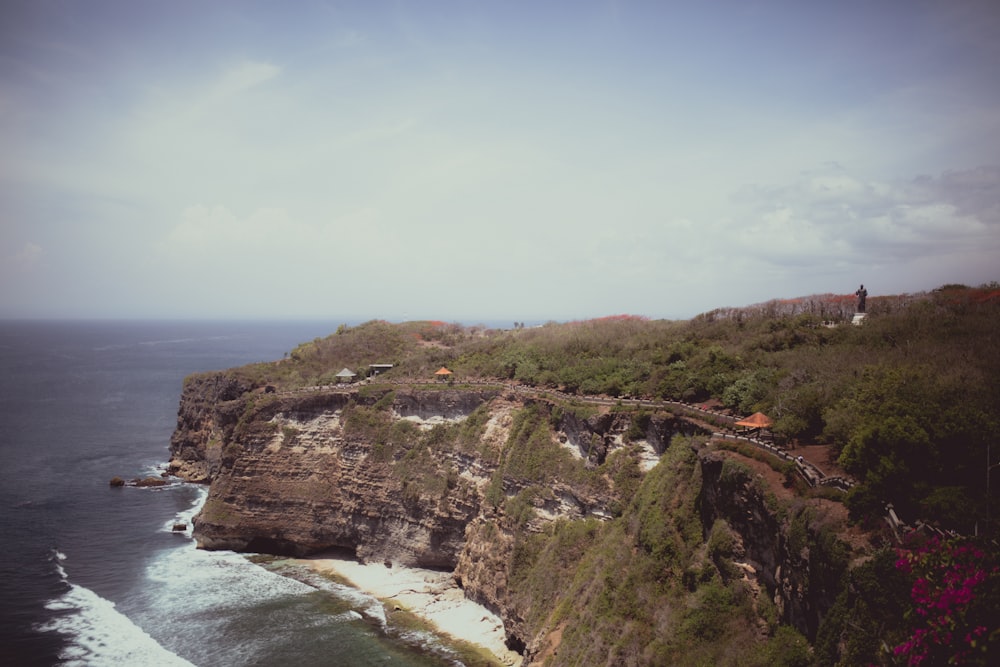 a scenic view of the ocean and a cliff